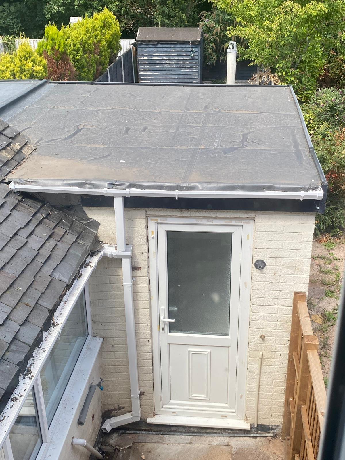 Felt-covered flat roof on a single-storey rear extension, viewed from above